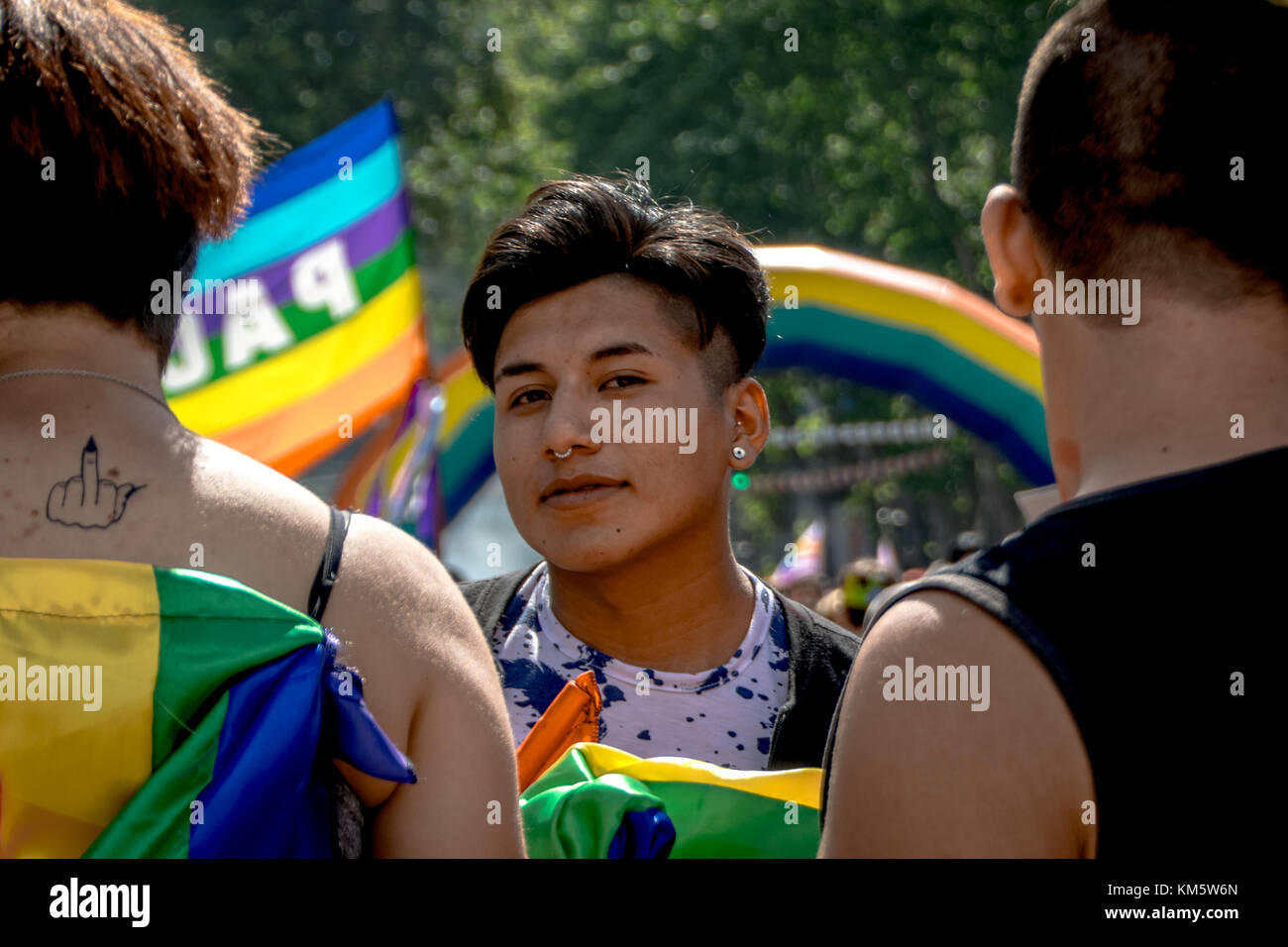 November 18, 2017 - Buenos Aires, Ciudad AutÃ³noma de Buenos Aires, Argentina - With a rainbow archway in the background, a young man is framed by his friends. Thousands of pride supporters marched from Plaza de Mayo to Congreso de la NaciÃ³n during the city's 26th annual Marcha del Orgullo Gay Credit: Jason Sheil/SOPA/ZUMA Wire/Alamy Live News Stock Photo