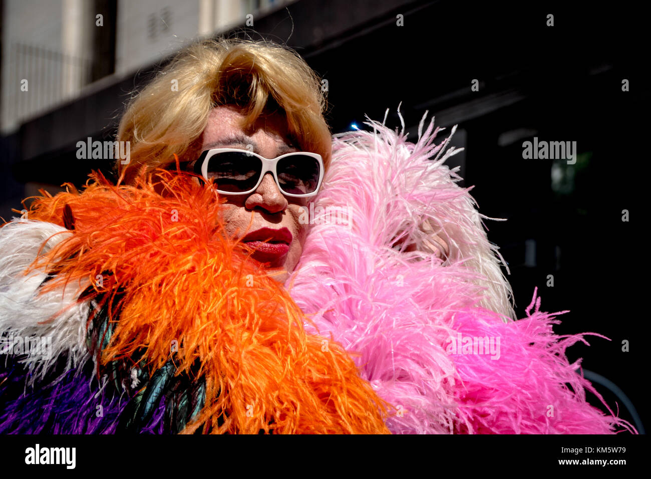 November 18, 2017 - Buenos Aires, Ciudad AutÃ³noma de Buenos Aires, Argentina - Sporting sunglasses, feathers, and faux fur; a supporter poses for the camera. Thousands of pride supporters marched from Plaza de Mayo to Congreso de la NaciÃ³n during the city's 26th annual Marcha del Orgullo Gay Credit: Jason Sheil/SOPA/ZUMA Wire/Alamy Live News Stock Photo