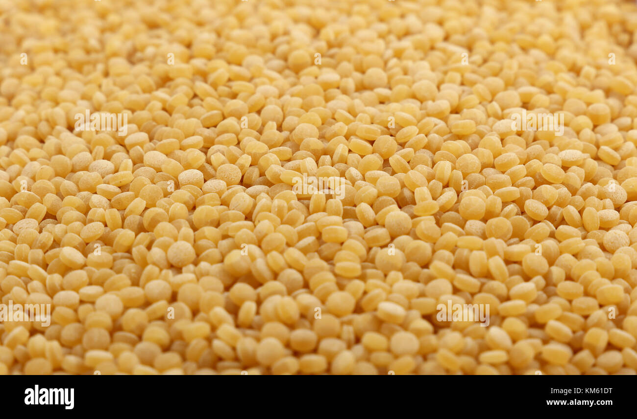 Traditional ptitim pasta (Israeli or pearl couscous) close up pattern background, low angle view, selective focus Stock Photo