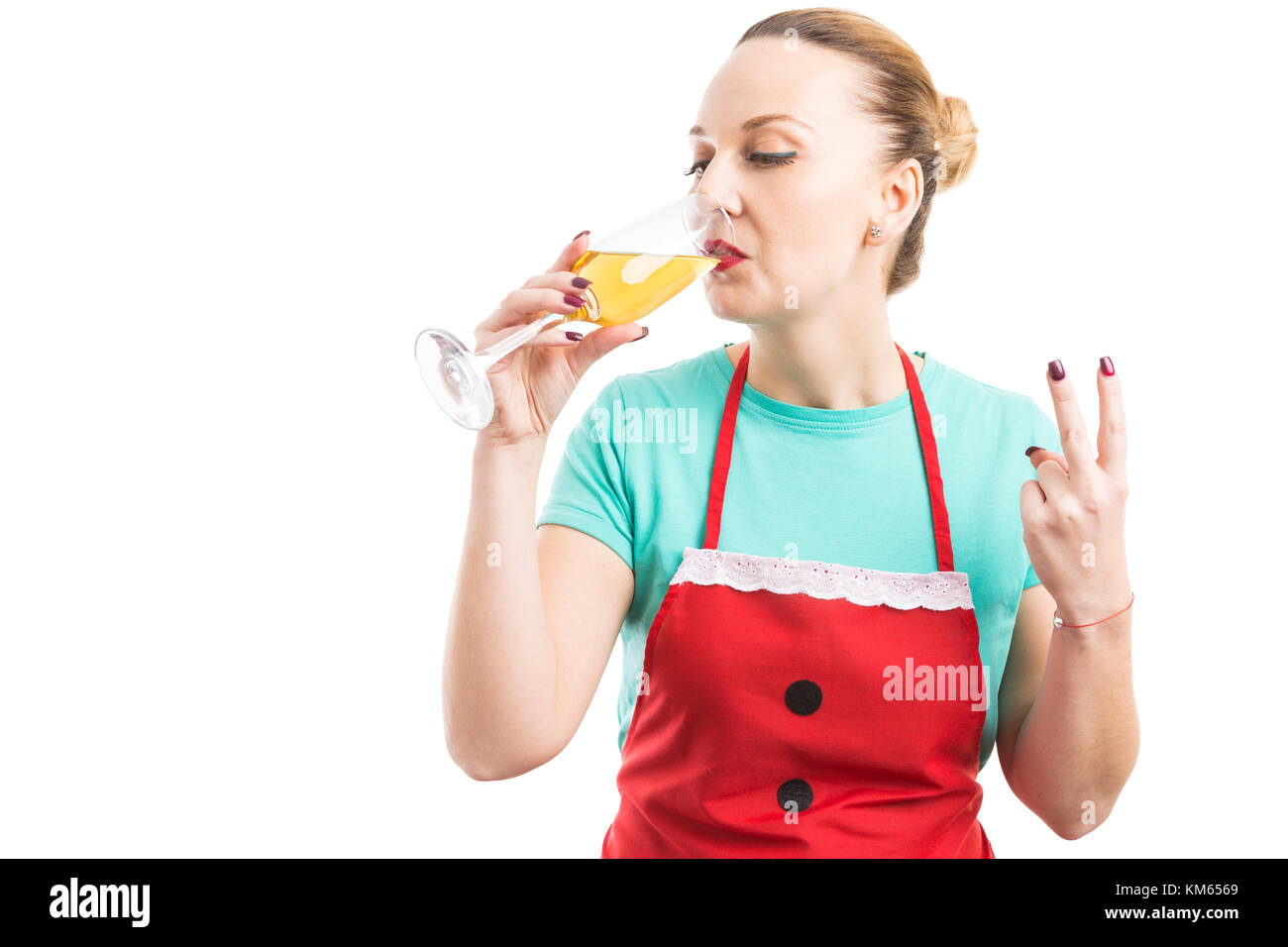 Housekeeper or housemaid drinking a glass of sparkling wine and showing number two with fingers isolated on white background Stock Photo