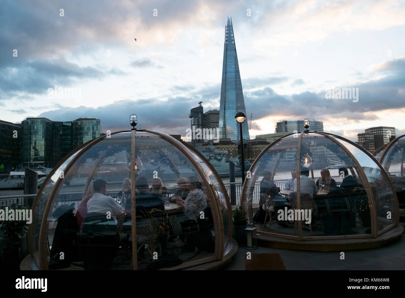 Pop up igloos being used for diners outside a hotel restaurant opposite
