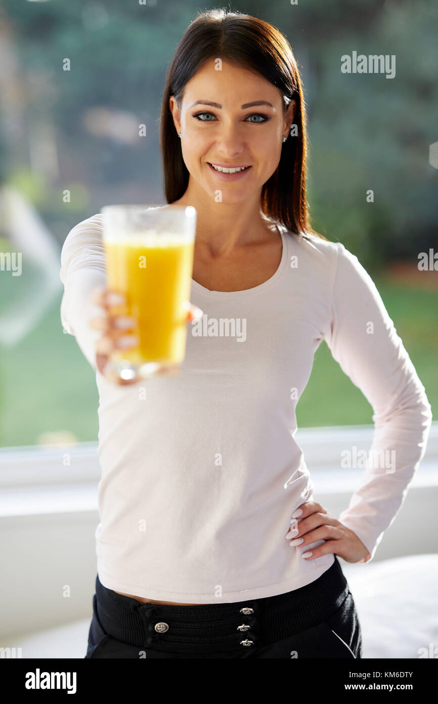 Girl holding a glass of orange juice Stock Photo
