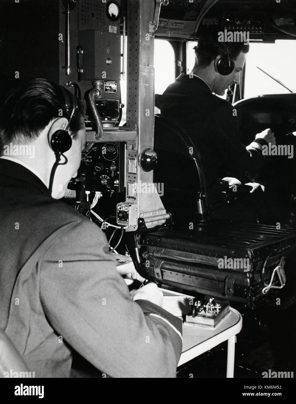 The interior of a 1950s SAS DC-4 airplane is shown in this image, highlighting the cockpit. The DC-4 was an important aircraft in early commercial aviation, and its cockpit design reflects the technology and design standards of the era. Stock Photo