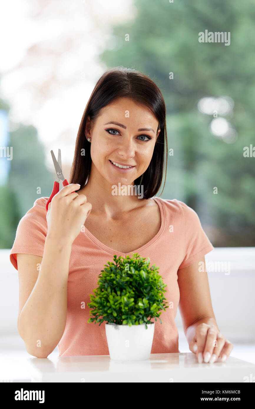 Woman pruning plant Stock Photo