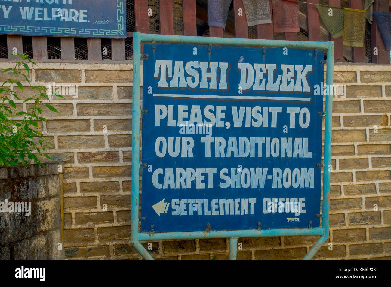 POKHARA, NEPAL - OCTOBER 06 2017: Informative sign of tashi delek, to visit the carpet show room in settlement office in Pokhara, Nepal Stock Photo