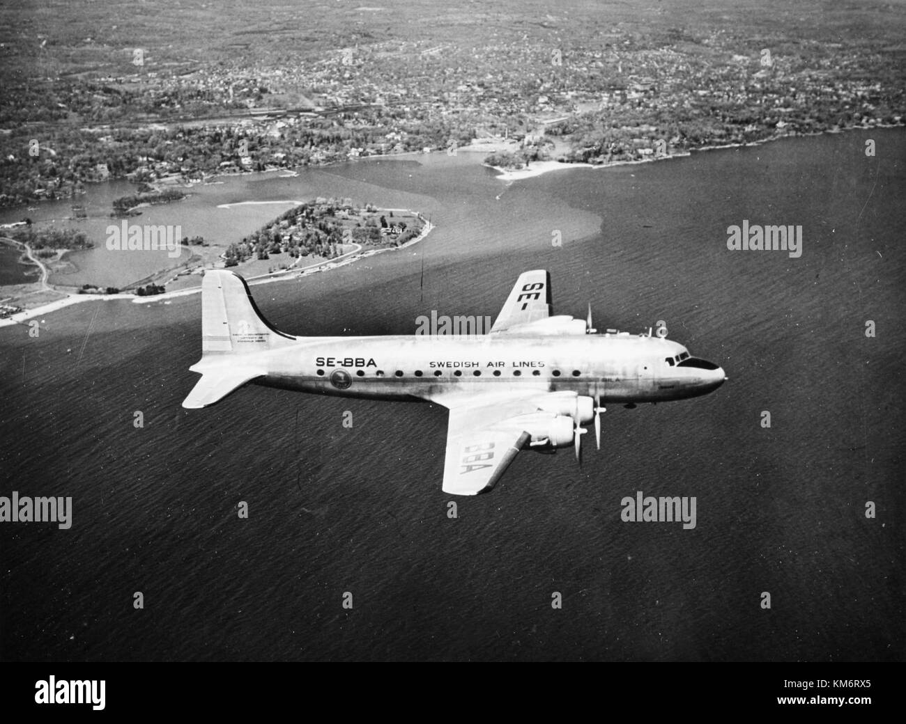 The SAS DC-4, named Sigtrygg Viking, was a prominent aircraft during the 1940s, representing the air travel era's evolution with Scandinavian Airlines, captured mid-flight. Stock Photo