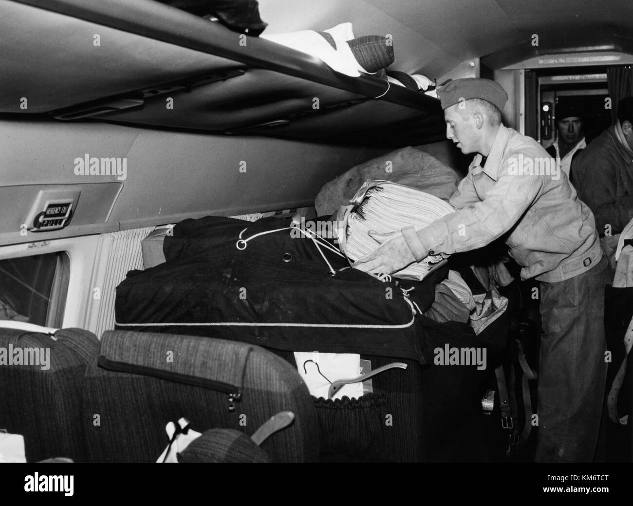 This image shows the interior of a 1950s SAS DC-4 aircraft, with visible cargo in the cabin. The DC-4 was a propeller-driven airliner used for passenger and freight transport during the mid-20th century. Stock Photo