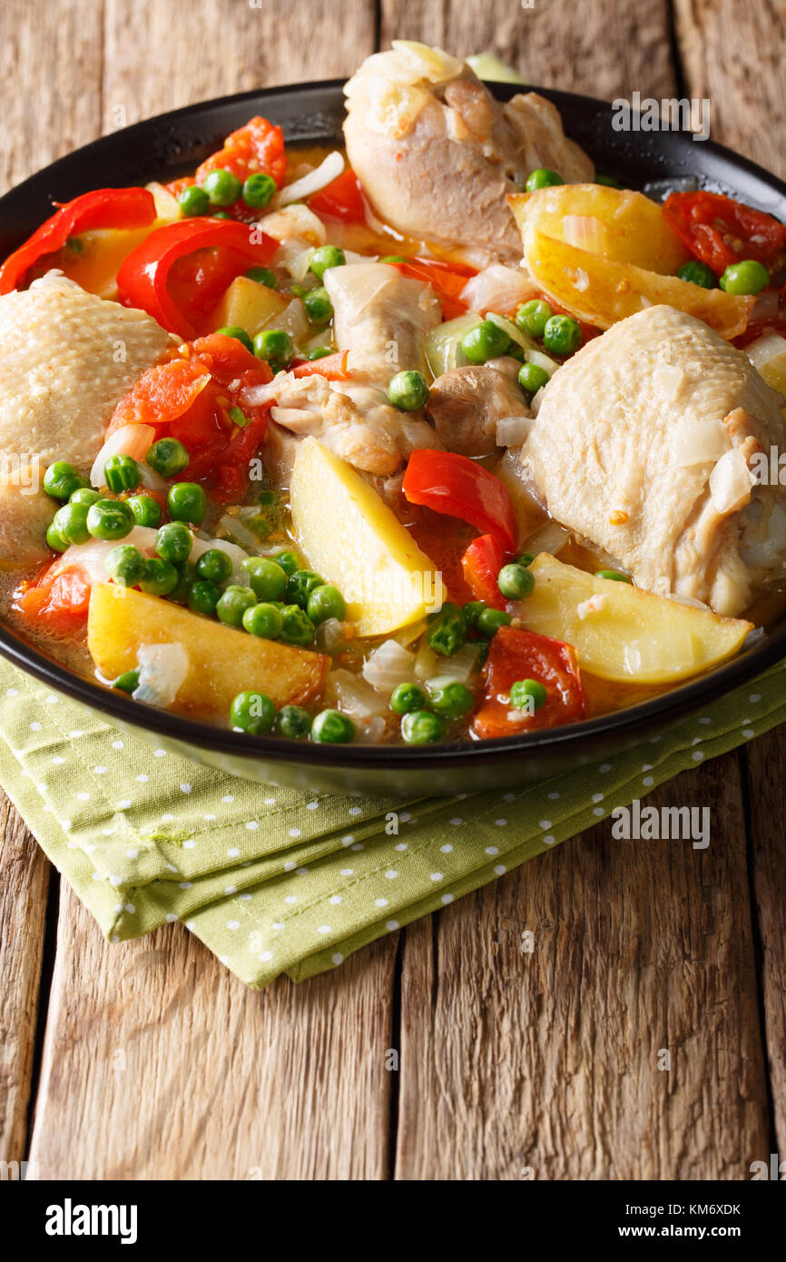 Philippine Afritada: chicken stew with vegetables close-up in a bowl on the table. vertical Stock Photo