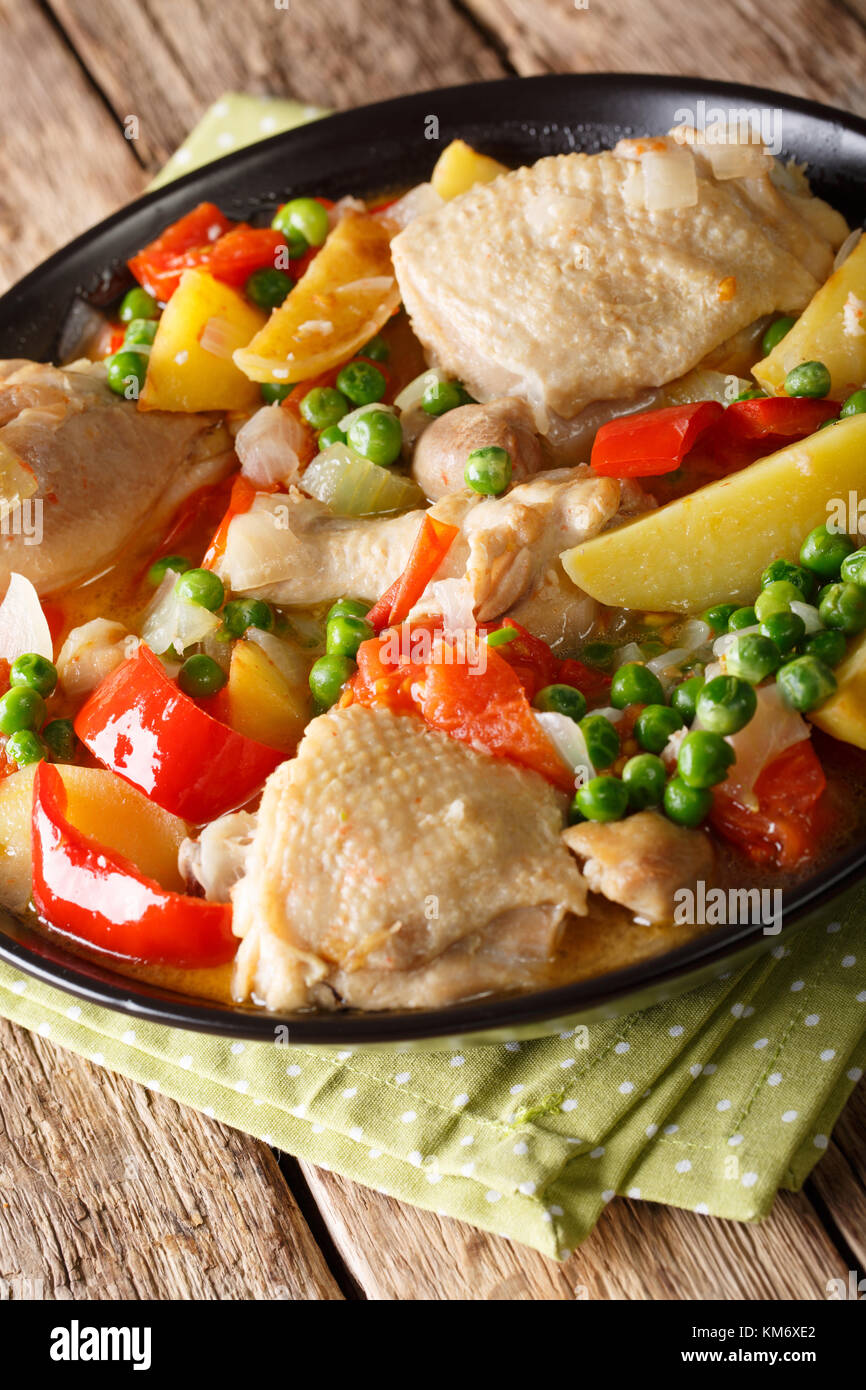 popular Filipino meal stew of chicken with vegetables - afritada closeup in a bowl on the table. vertical Stock Photo
