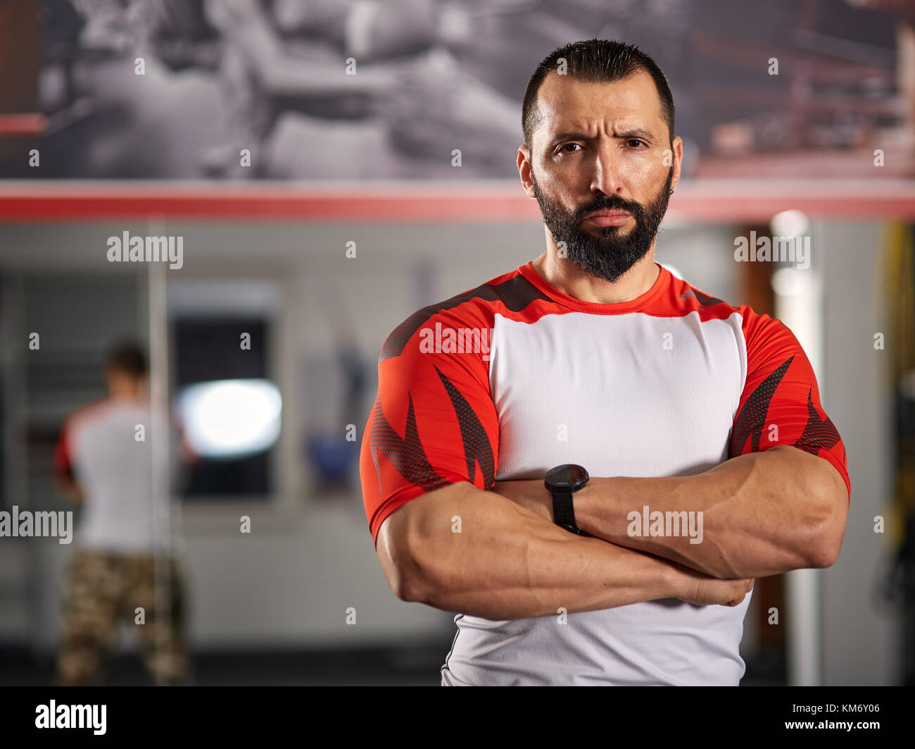 Confident and motivated fitness coach posing in the gym Stock Photo Alamy