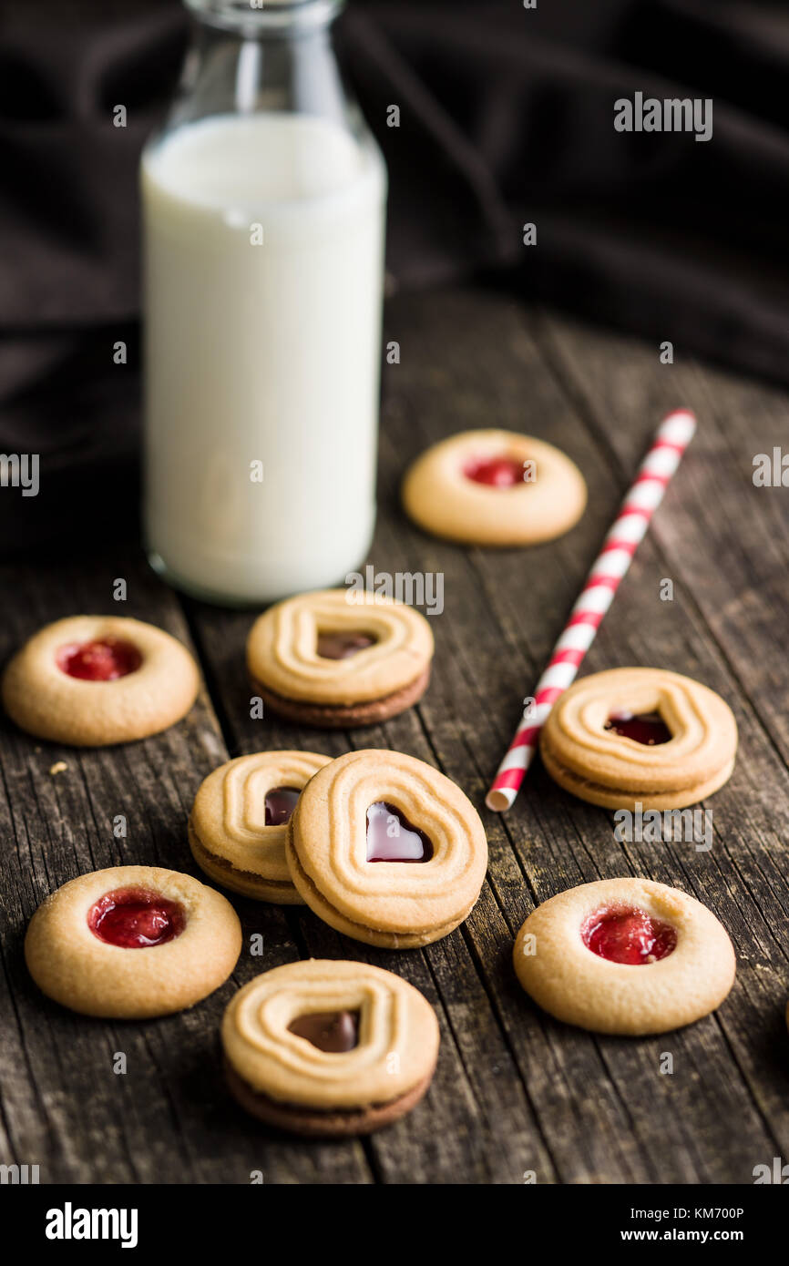 Sweet jelly cookies and milk on old wooden table Stock Photo Alamy