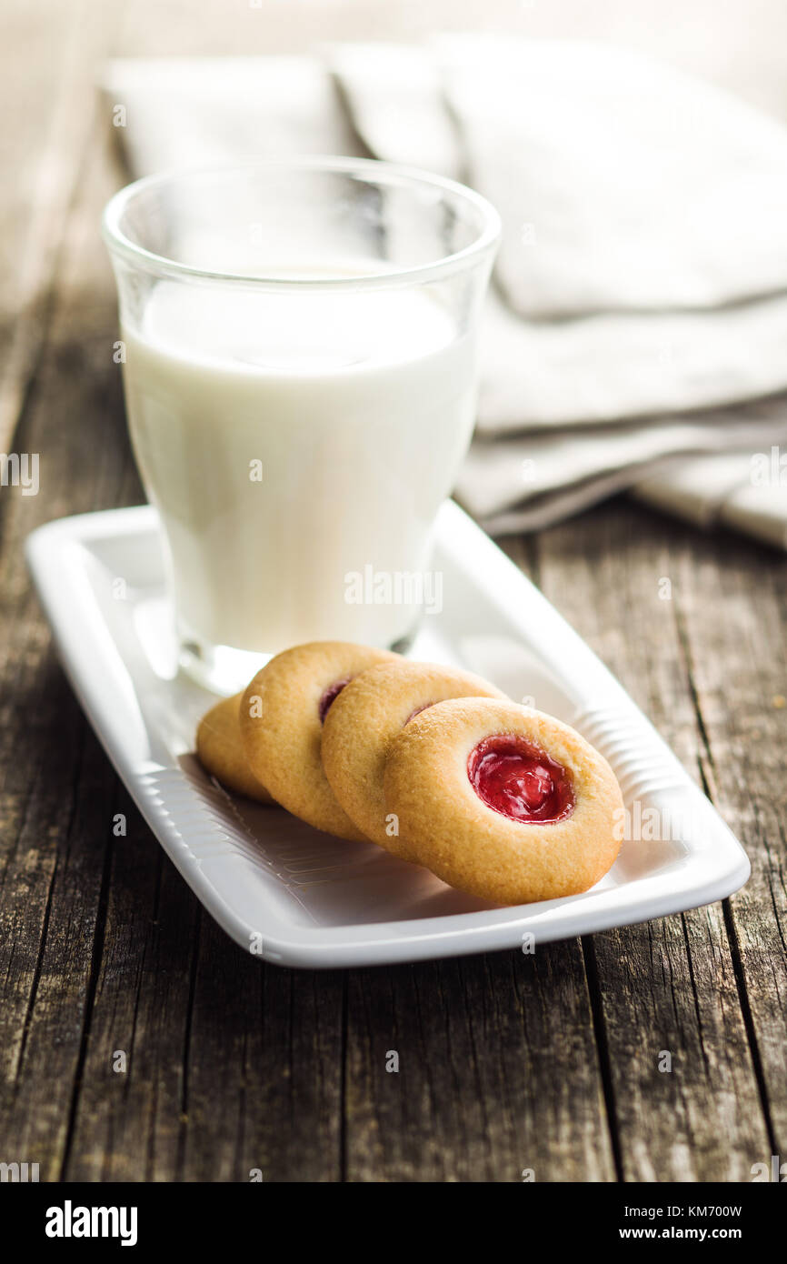Sweet jelly cookies and milk on old wooden table Stock Photo Alamy