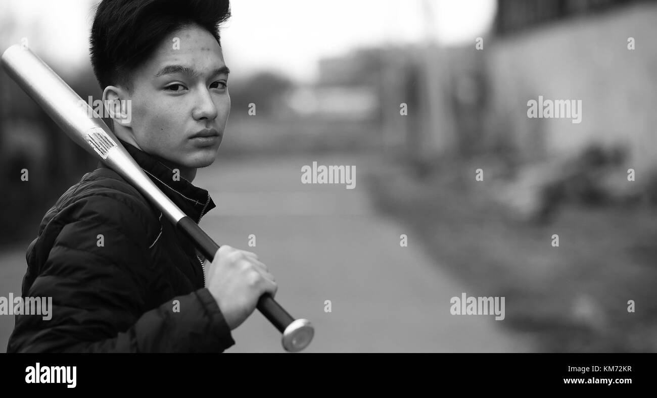 Black White photo of Asian young man outdoors posing Stock Photo - Alamy