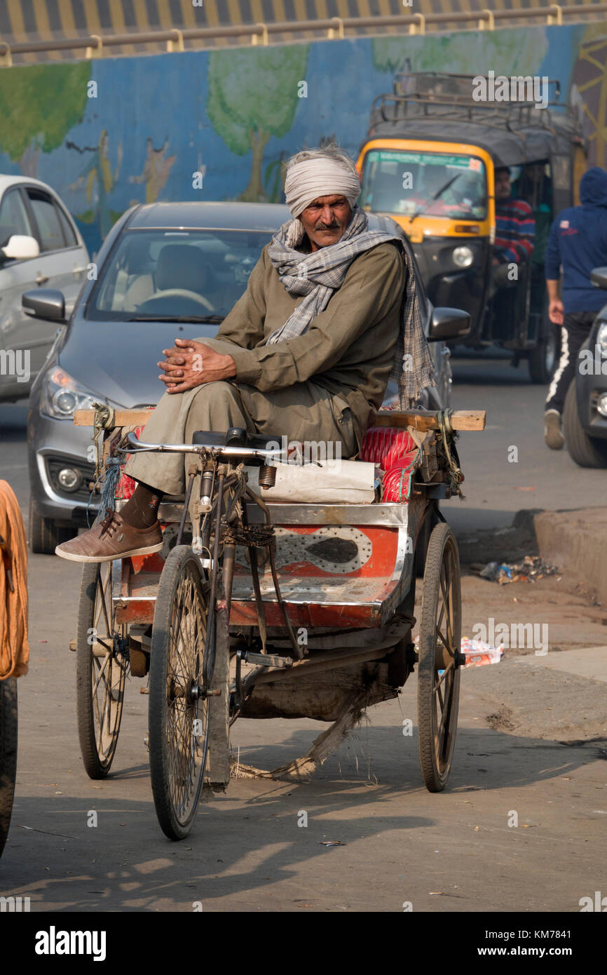 Punjabi man sits on his cycle rickshaw in Amritsar, India Stock Photo