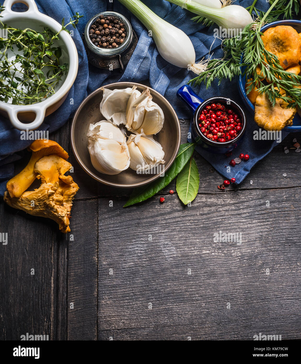 Autumn seasonal  cooking ingredients with harvest vegetables, greens and mushrooms on dark rustic wooden background, top view Stock Photo