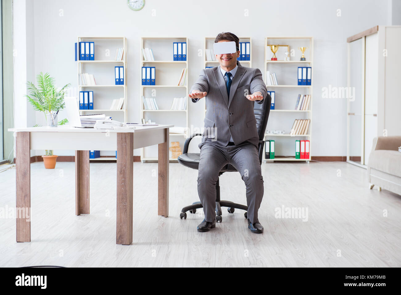 Businessman exercising in office wearing VR glasses Stock Photo - Alamy