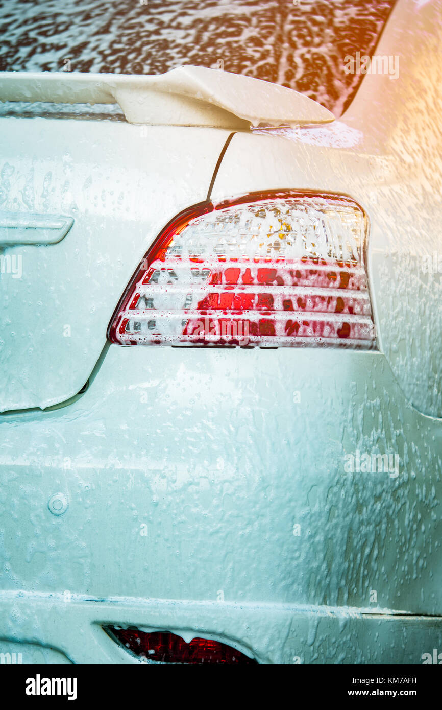 Outdoor car wash with foam soap. Stock Photo