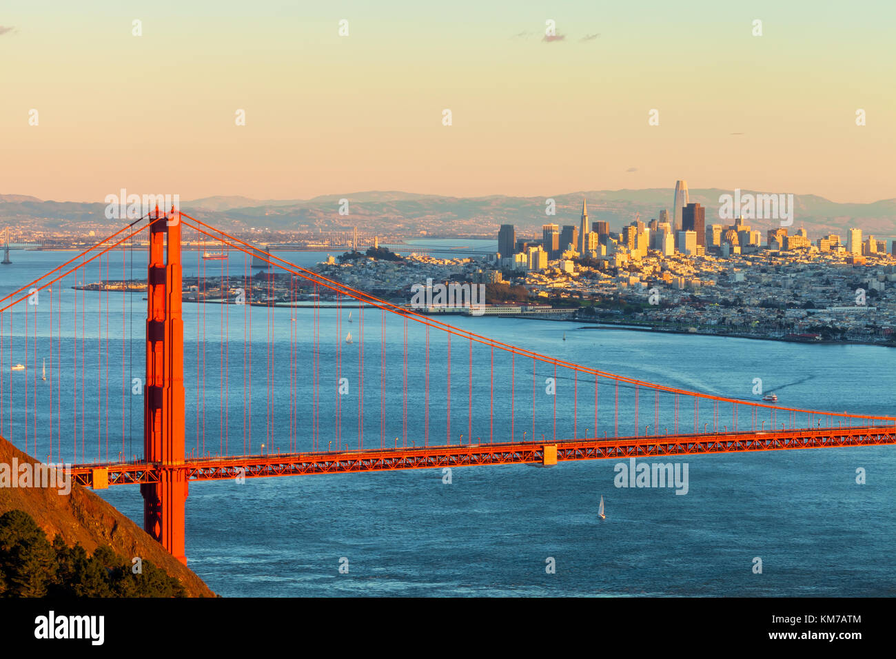 Golden Gate Bridge, with the San Francisco City lighting up by evening  sunlight in the background, California, United States Stock Photo - Alamy, image size:1300x956