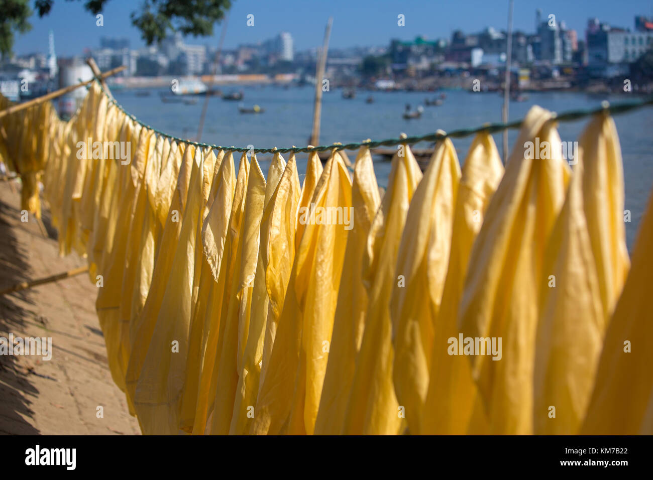 Clothes are hanging to dry in sunshine at Kamrangir Char point of Buriganga, Dhaka, Bangladesh. Stock Photo