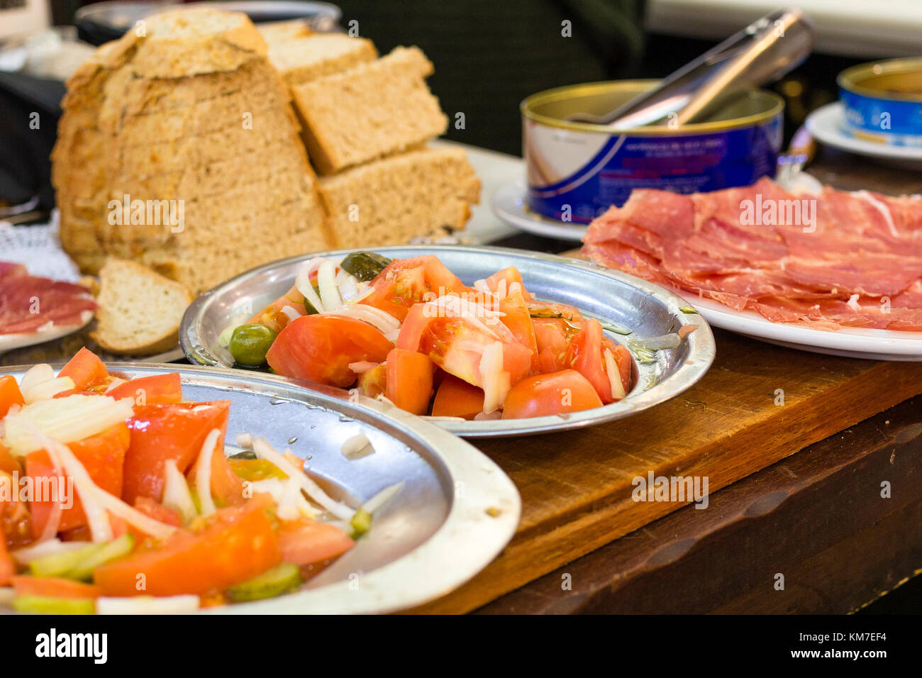 Cold meat read and and salad vegetables on a table in a Spanish