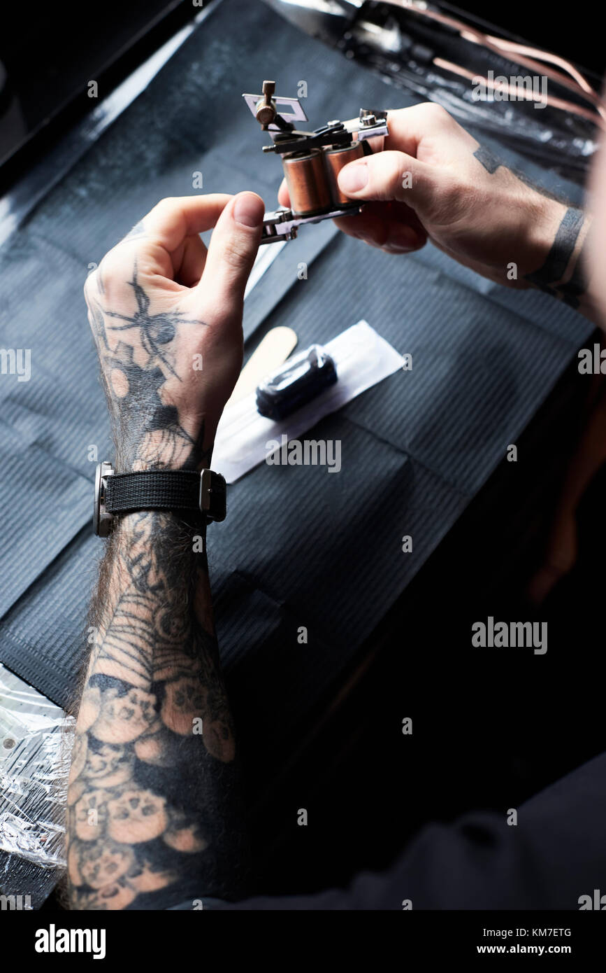 London, UK, Tattoo artist at work in his local business studio