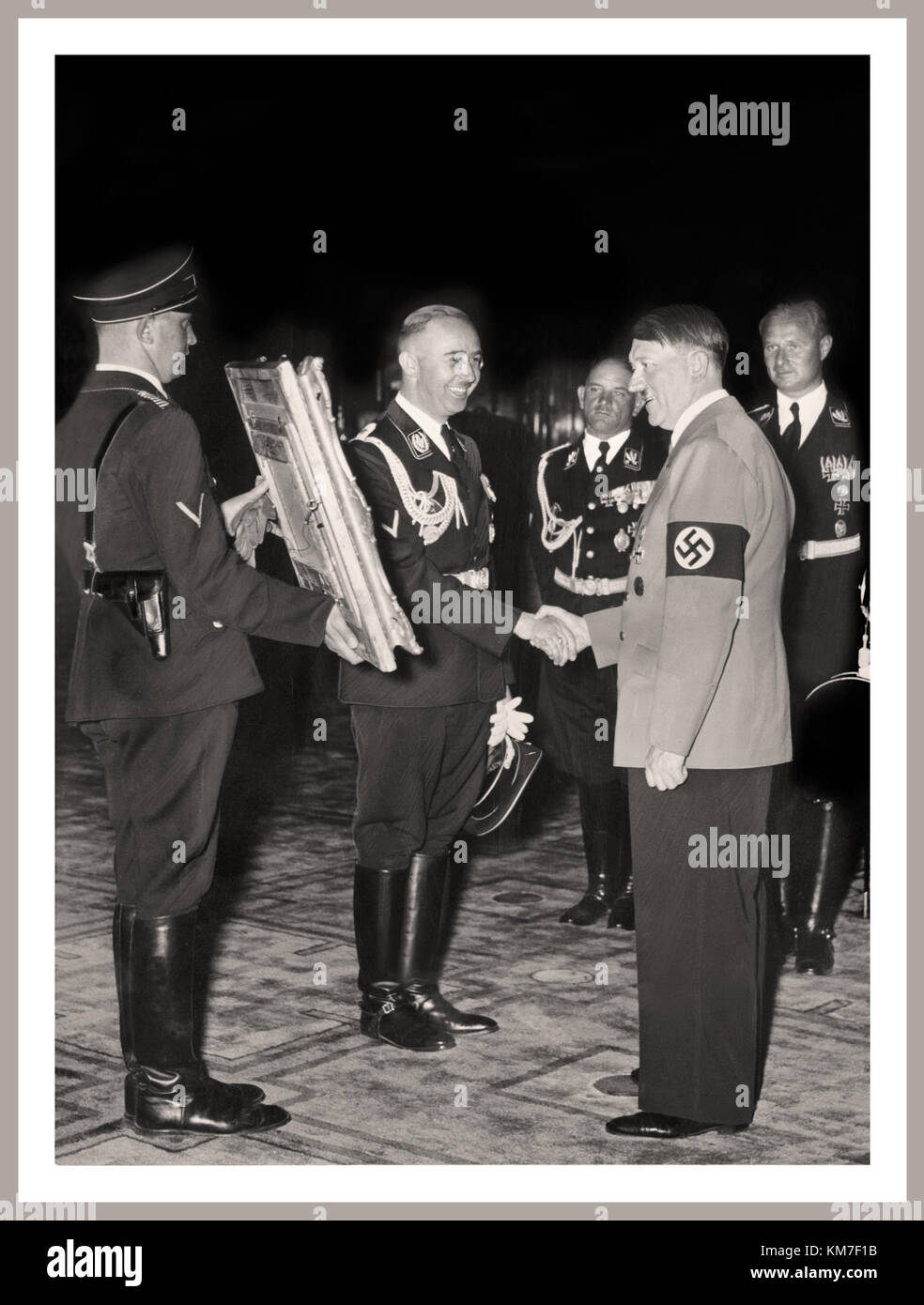 VINTAGE NAZI HITLER BIRTHDAY Hitler is presented with a painting of his hero, Frederick the Great, by Heinrich Himmler (centre), the head of the SS to mark The Fuhrer's 50th birthday in 1939 Stock Photo