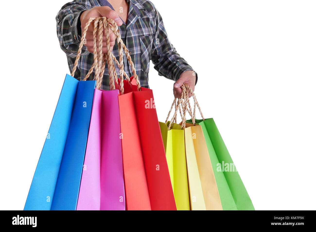 man hand holding colorful shopping bags isolated on white background Stock Photo