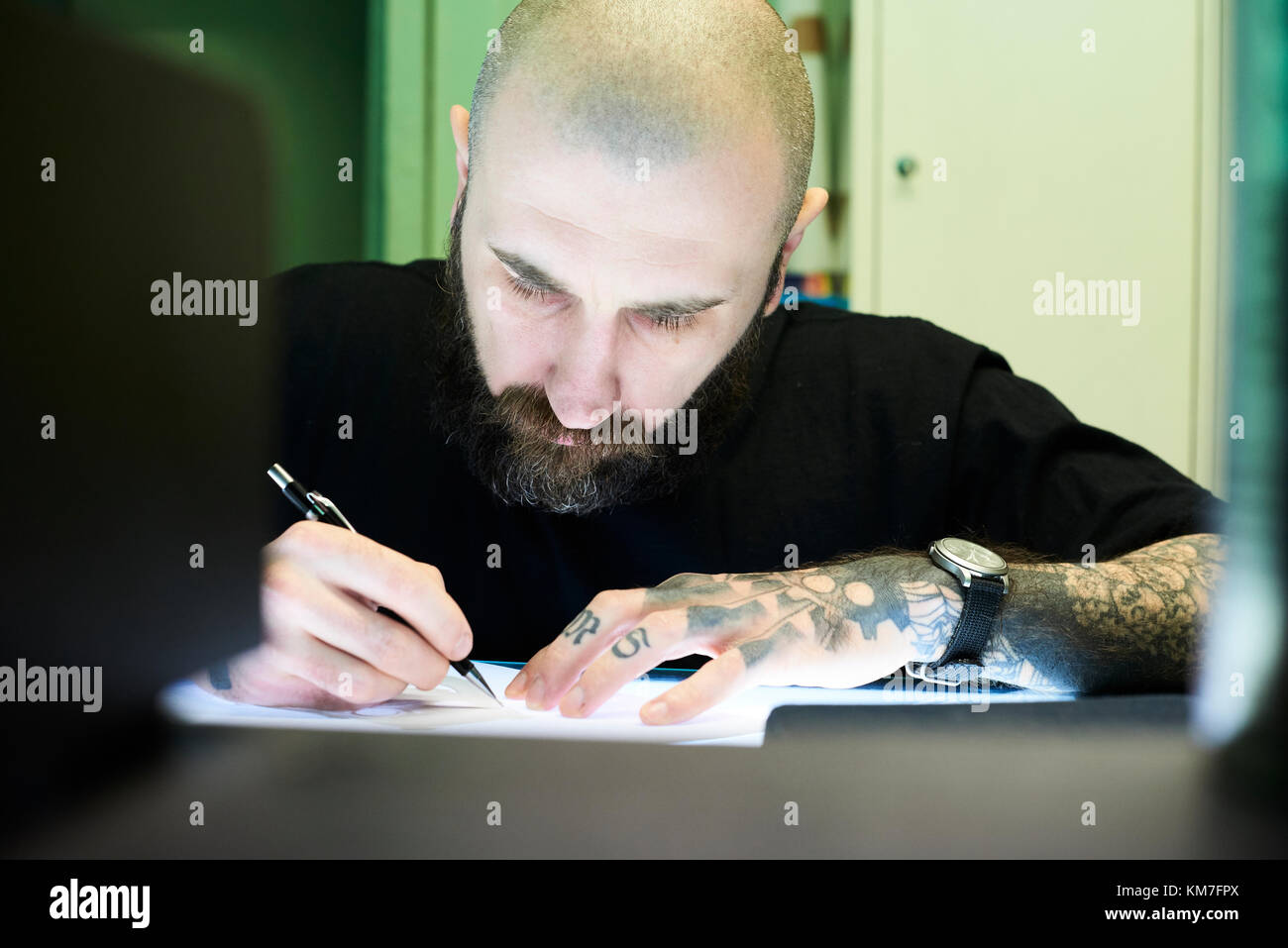 London, UK, Tattoo artist at work in his local business studio, tattooist Stock Photo