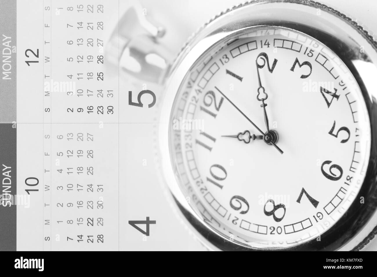 Watch on calendar page numbers Stock Photo