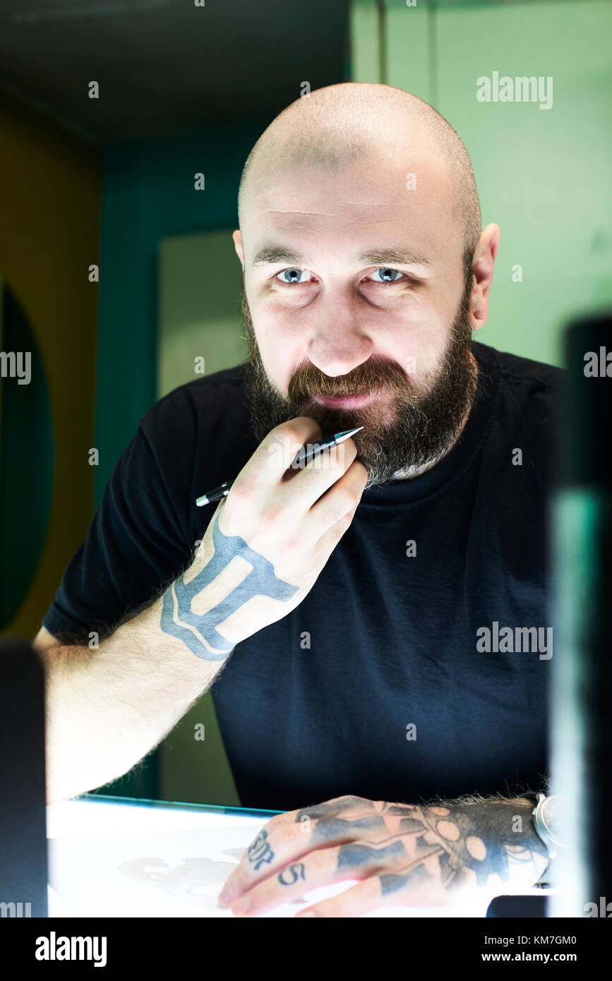 London, UK, Tattoo artist at work in his local business studio, tattooist Stock Photo