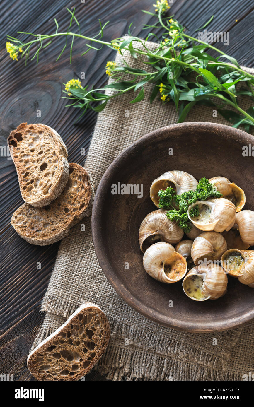 Bowl of cooked snails Stock Photo Alamy