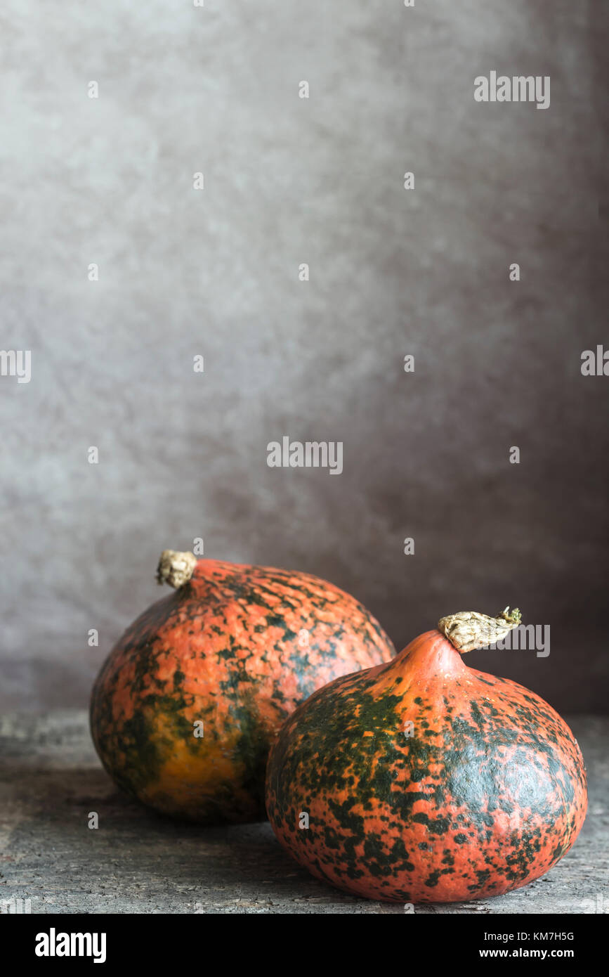 Two hokkaido pumpkins on the wooden background Stock Photo - Alamy
