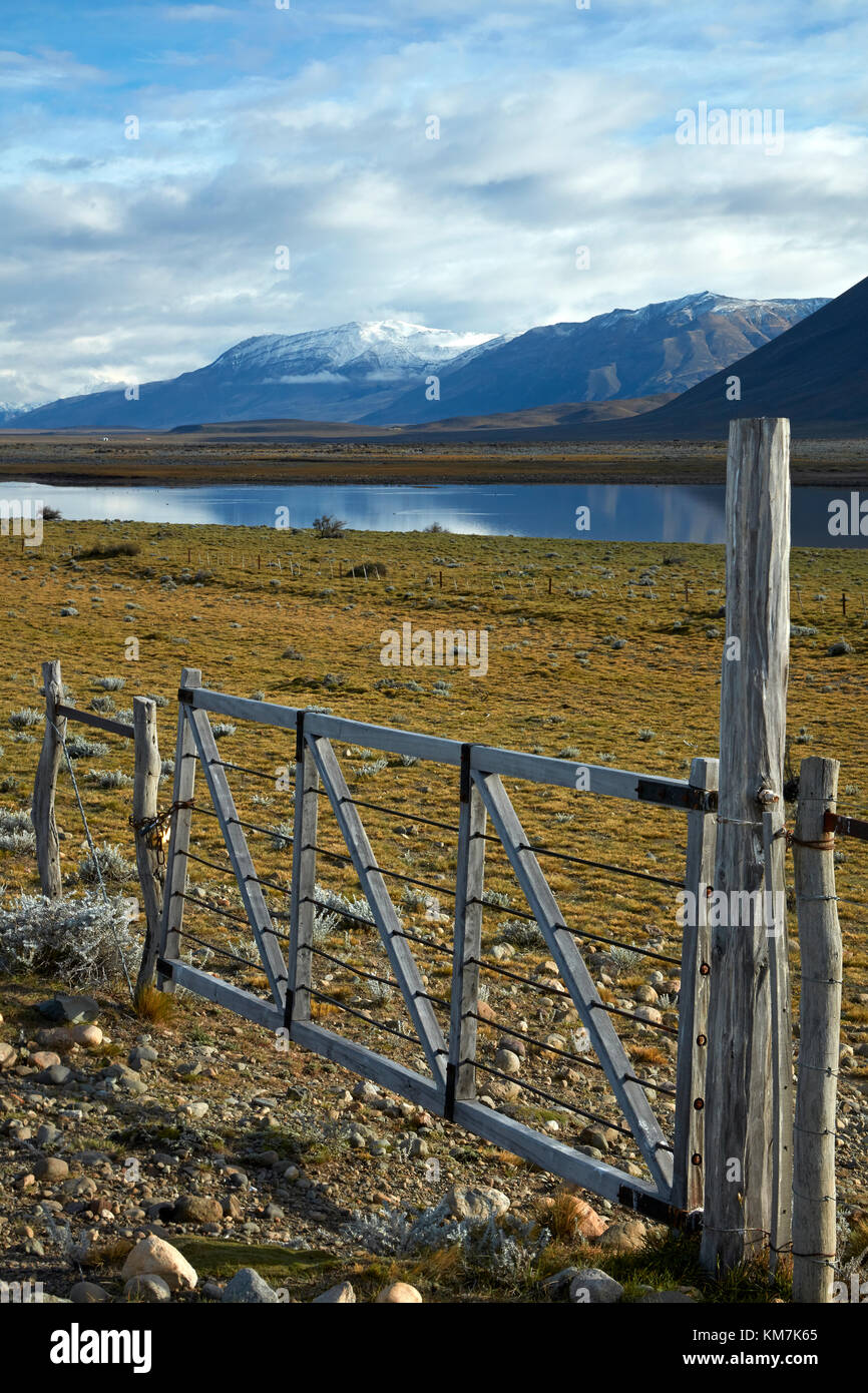 Gate, farmland and lake near EL Chalten, Patagonia, Argentina, South America Stock Photo