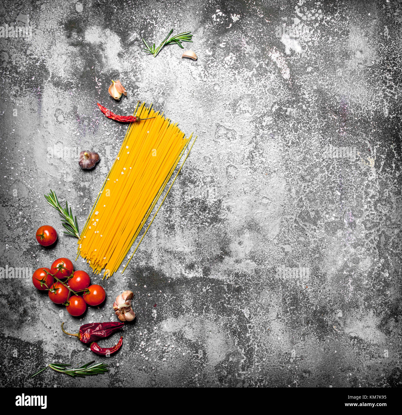 Pasta background. Spaghetti with tomatoes, rosemary and garlic.On ...