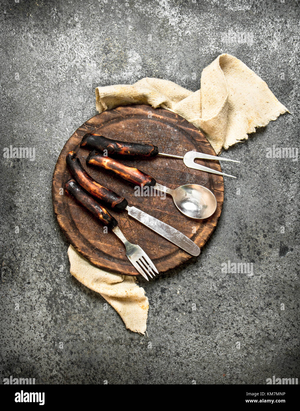 Serving background. Cutlery on the old Board. On rustic background ...