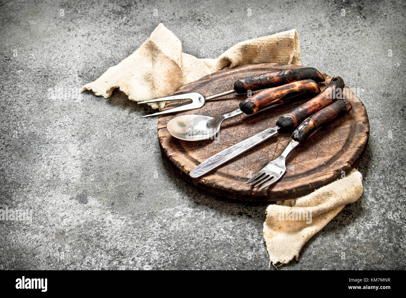 Serving background. Cutlery on the old Board. On rustic background ...