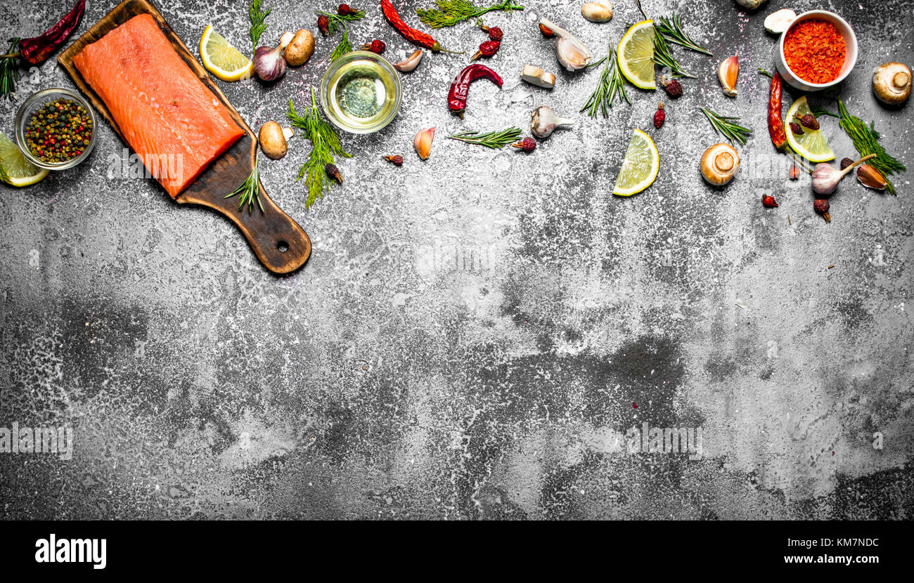 Raw fish. Fresh salmon fillet with herbs and spices. On rustic ...