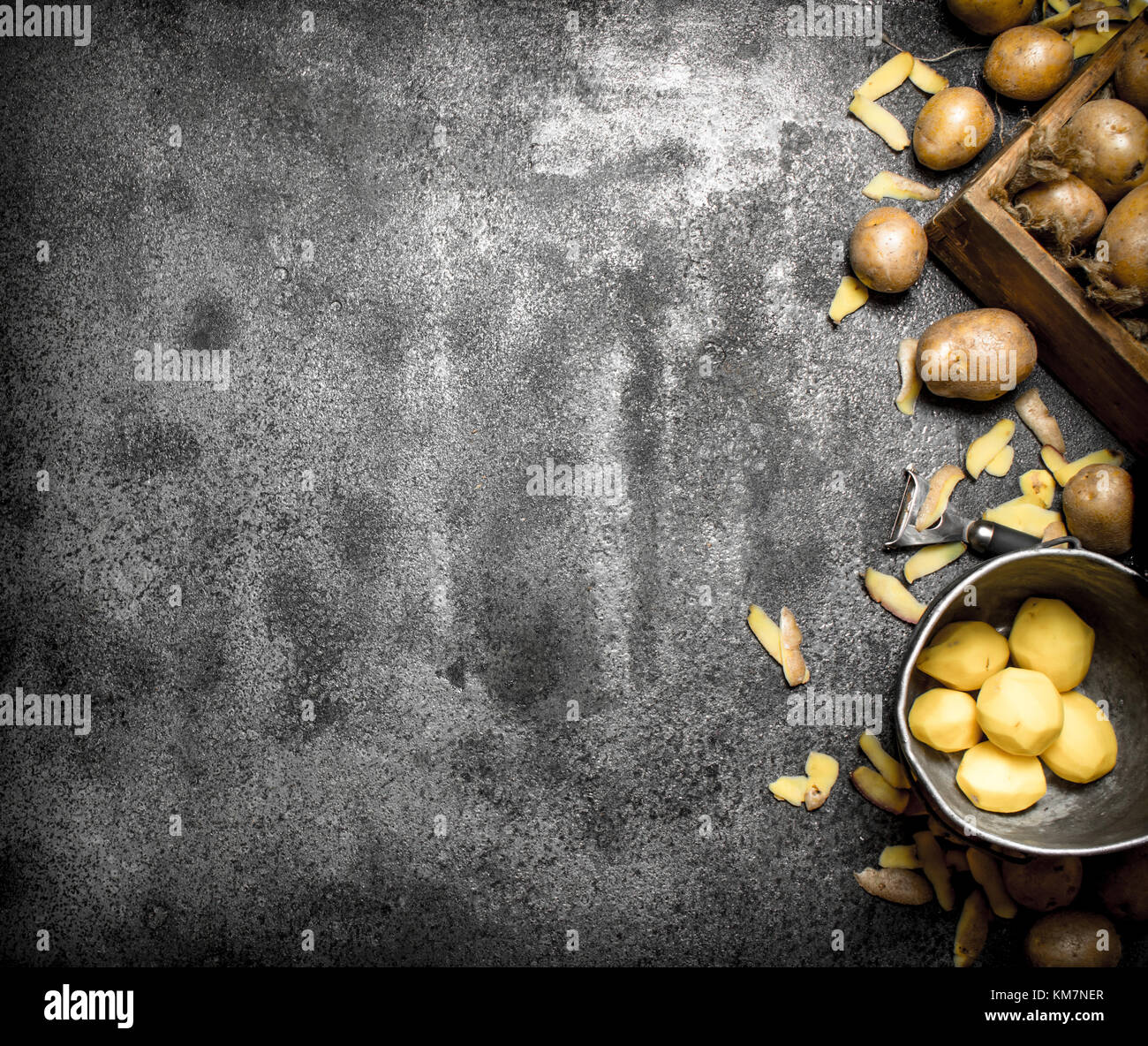 Fresh peeled potatoes . On the rustic background Stock Photo - Alamy