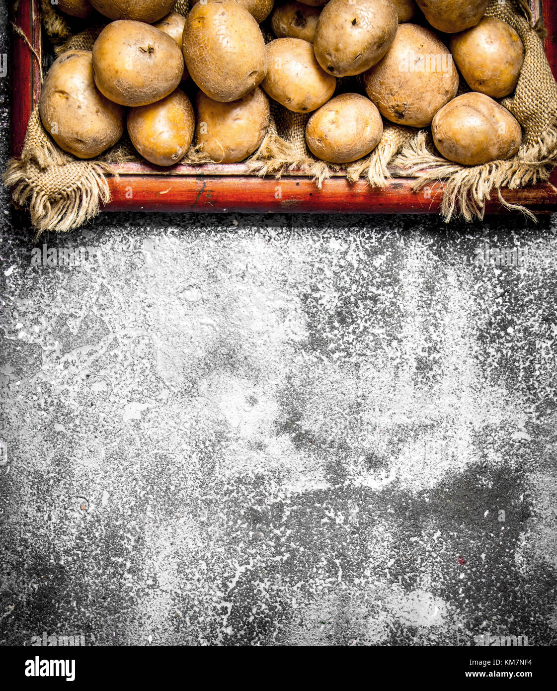 Fresh potatoes in an old tray. On rustic background Stock Photo - Alamy