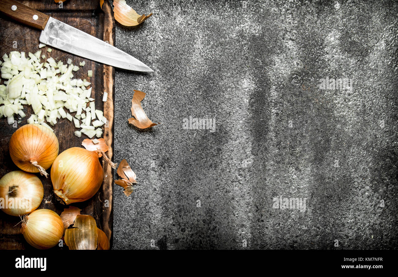 Fresh chopped onion on the old Board. On rustic background Stock Photo ...