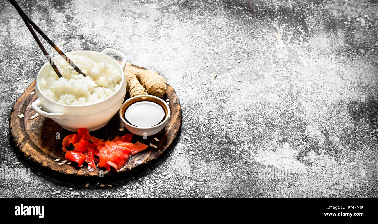 Asian food. Boiled rice with soy sauce and pickled ginger. On an old ...