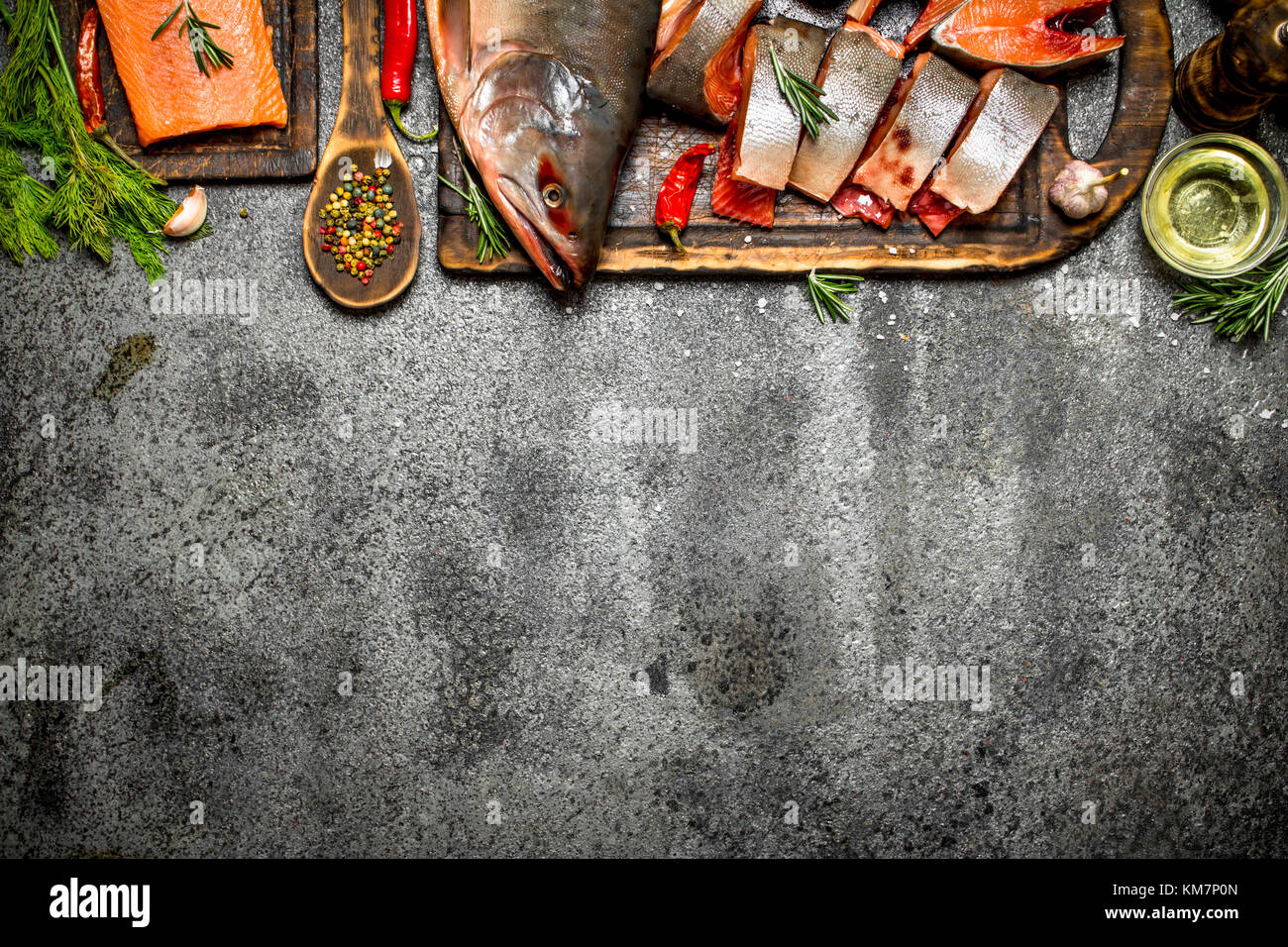 Raw fish. Cut fresh salmon with herbs and spices. On the rustic table ...