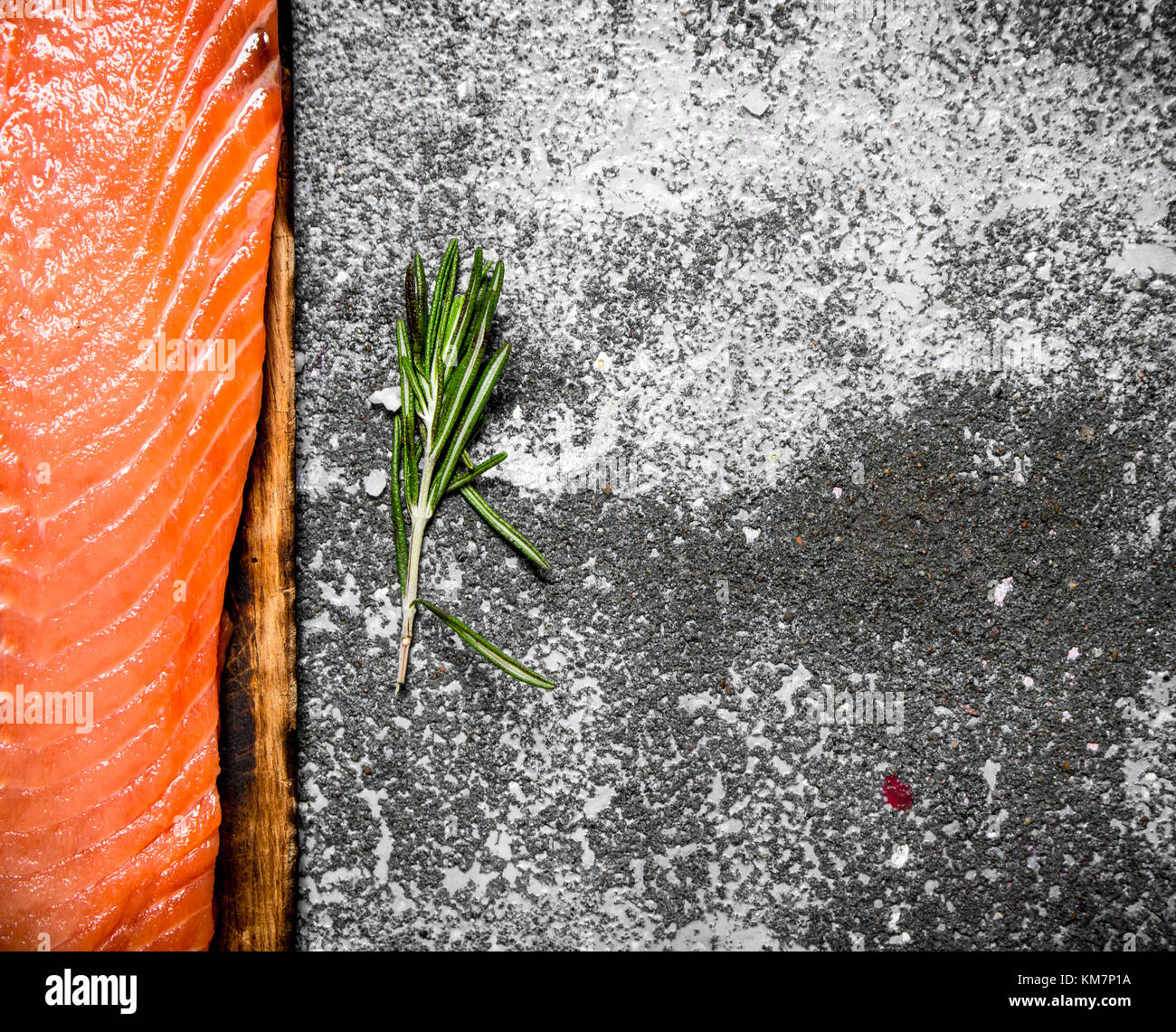 Raw fish. Fresh salmon fillet on the old Board. On rustic background ...