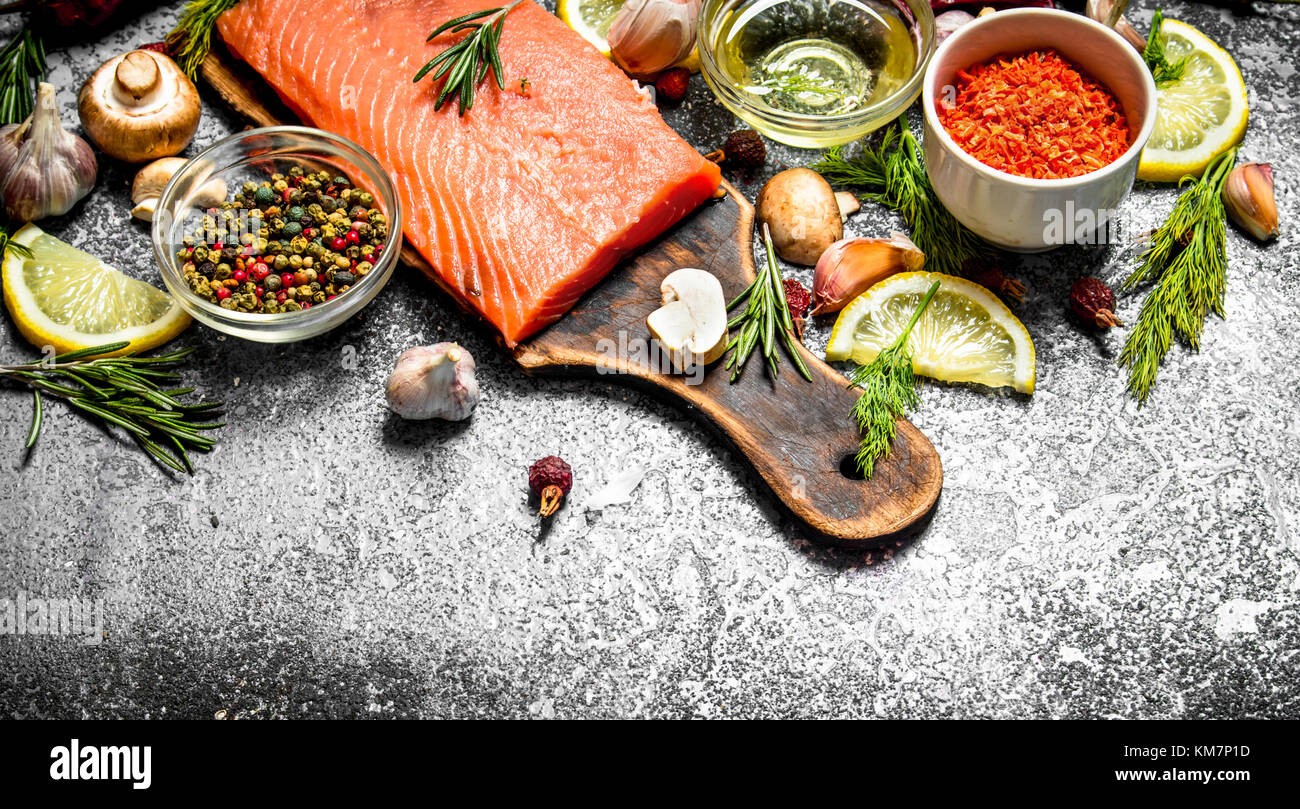 Raw fish. Fresh salmon fillet with herbs and spices. On rustic ...