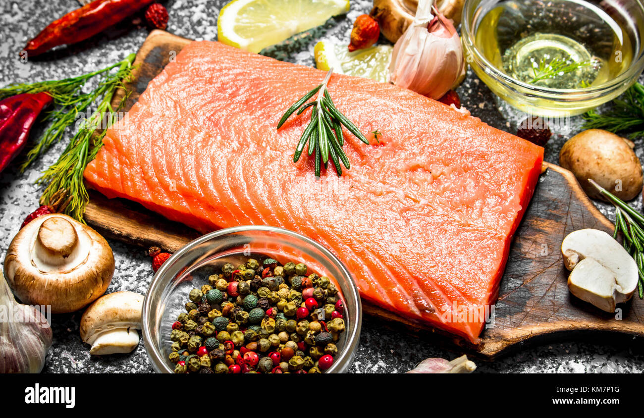 Raw fish. Fresh salmon fillet with herbs and spices. On rustic ...