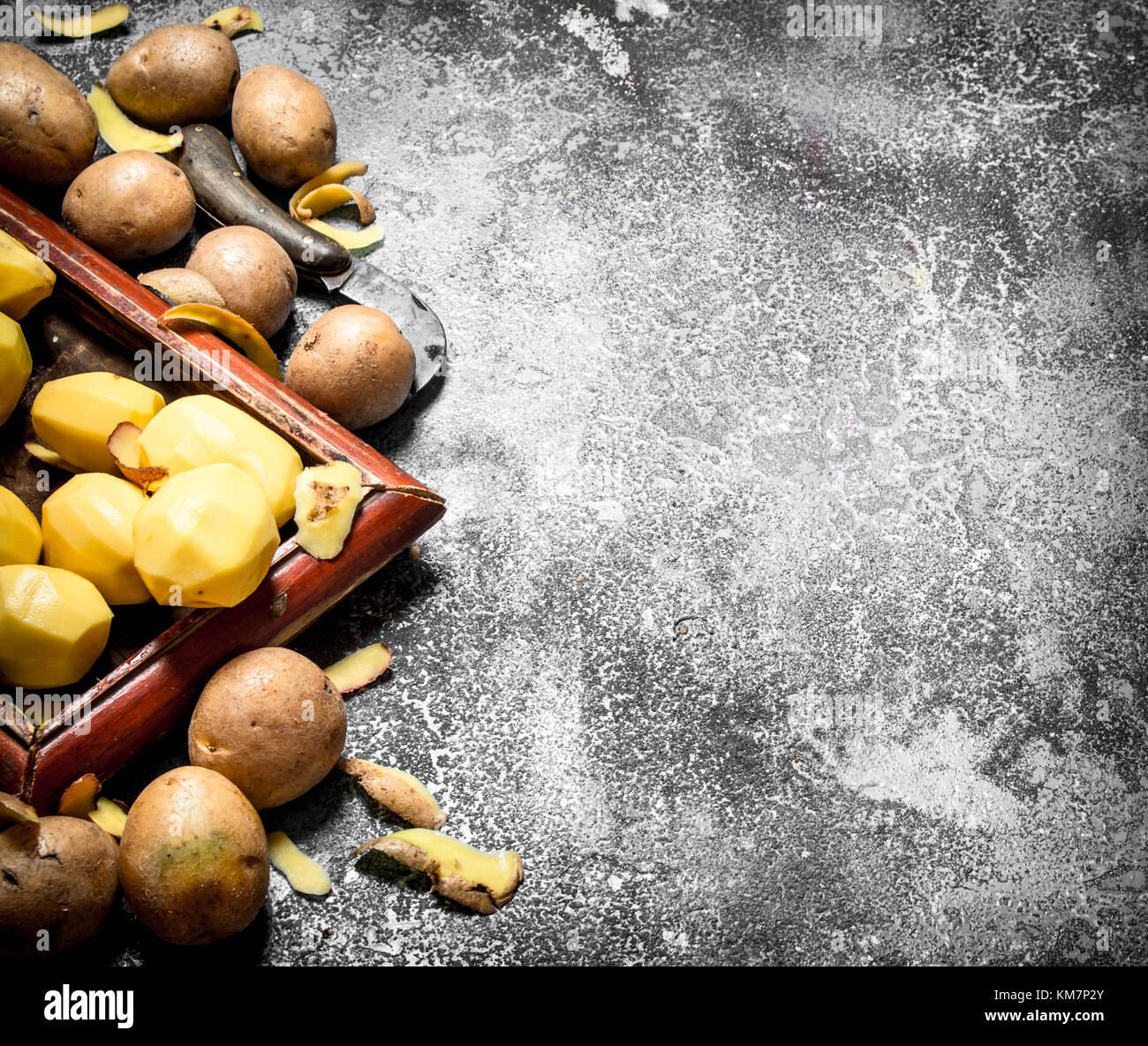 Fresh potatoes in an old tray. On rustic background Stock Photo - Alamy