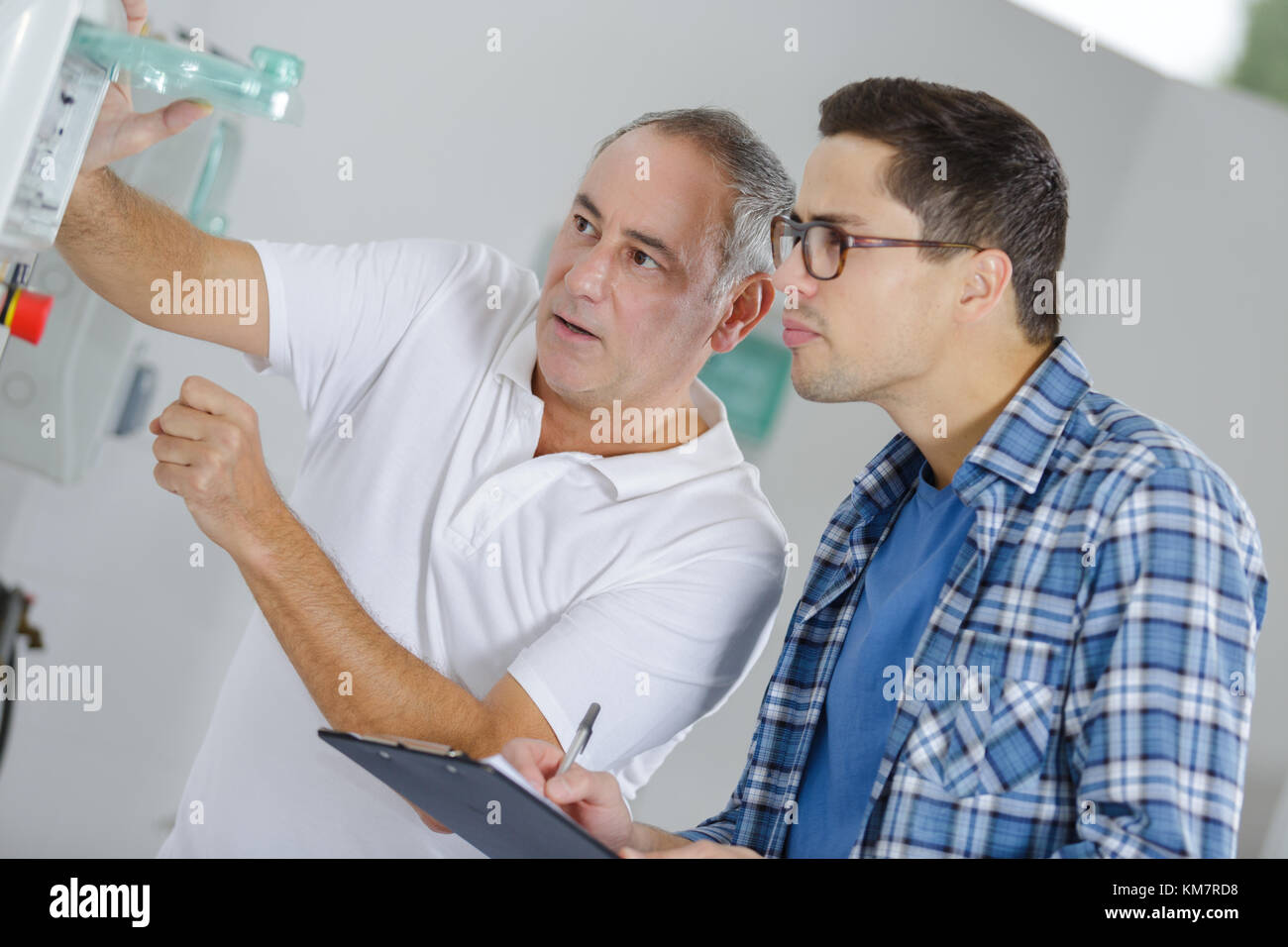 two worker on a machine Stock Photo - Alamy