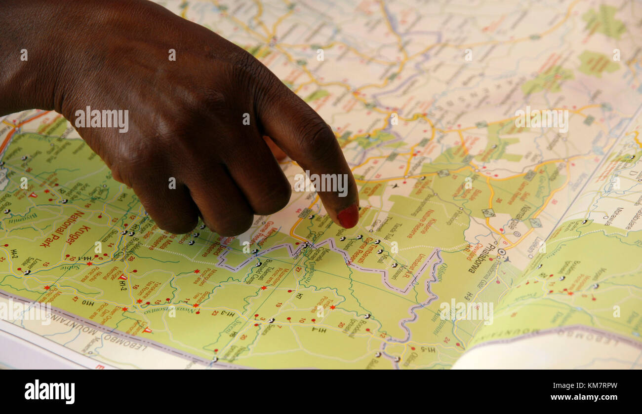 African woman searching on a map Stock Photo