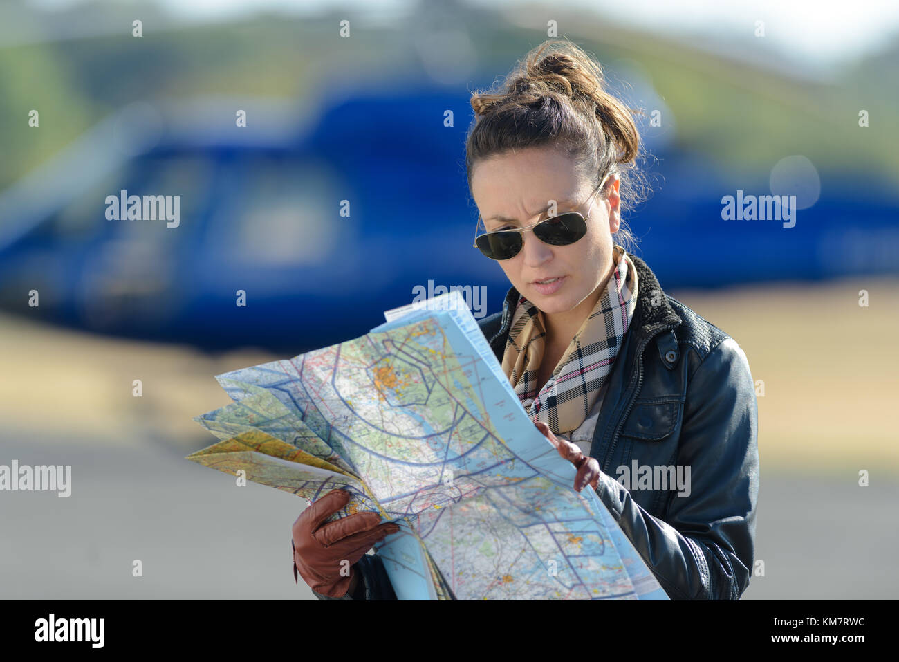 woman reading a map in the tarmac Stock Photo - Alamy