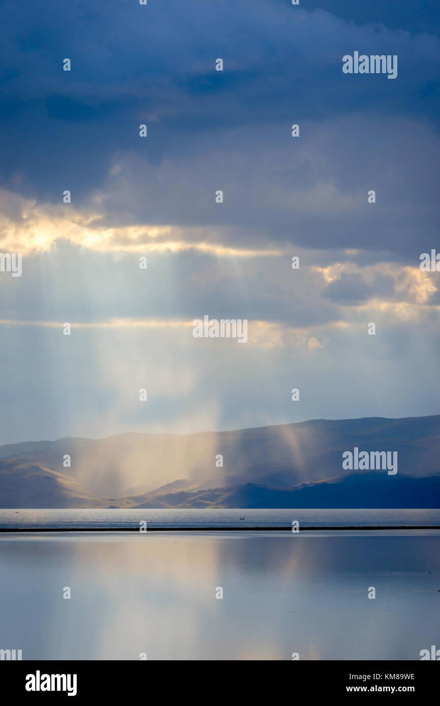 Storm with sun rays over beautiful mountains by Song Kul lake, Kyrgyzstan Stock Photo
